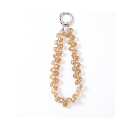 Charm effet cristal Cristal Gold, perles facettées et anneau métal, sur fond blanc