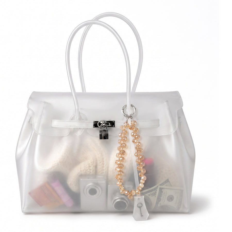 Charm effet cristal Cristal Gold noué sur l anse d un sac Jelly transparent