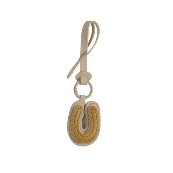 Charm lettre en cuir, le bijou de sac à ton initiale, coloris U · Miel